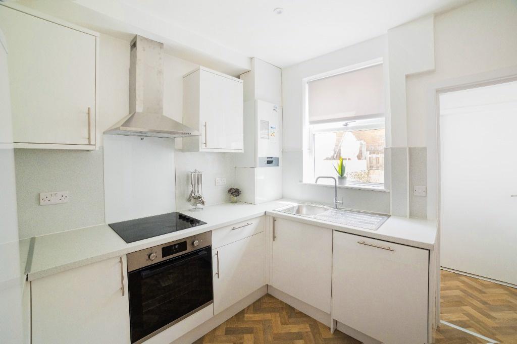 Bright modern kitchen with white units and good...