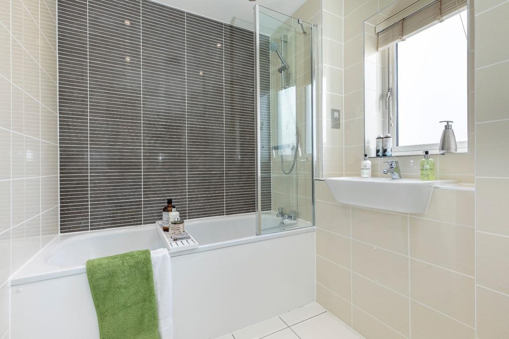 Family bathroom with shower over bath