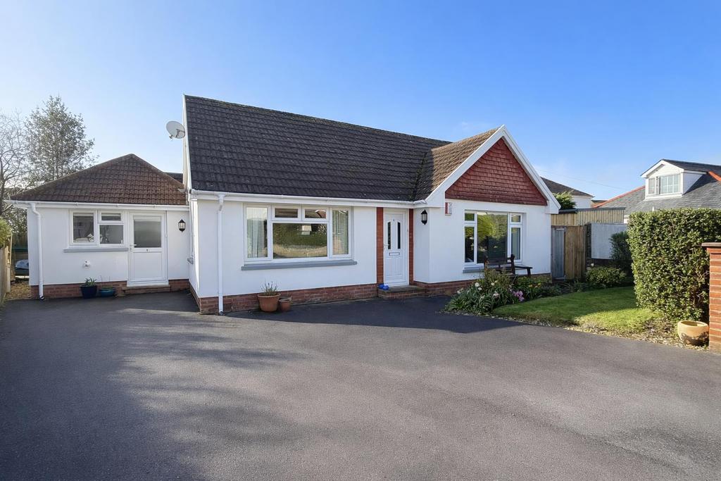 Charming white bungalow with red accents.png