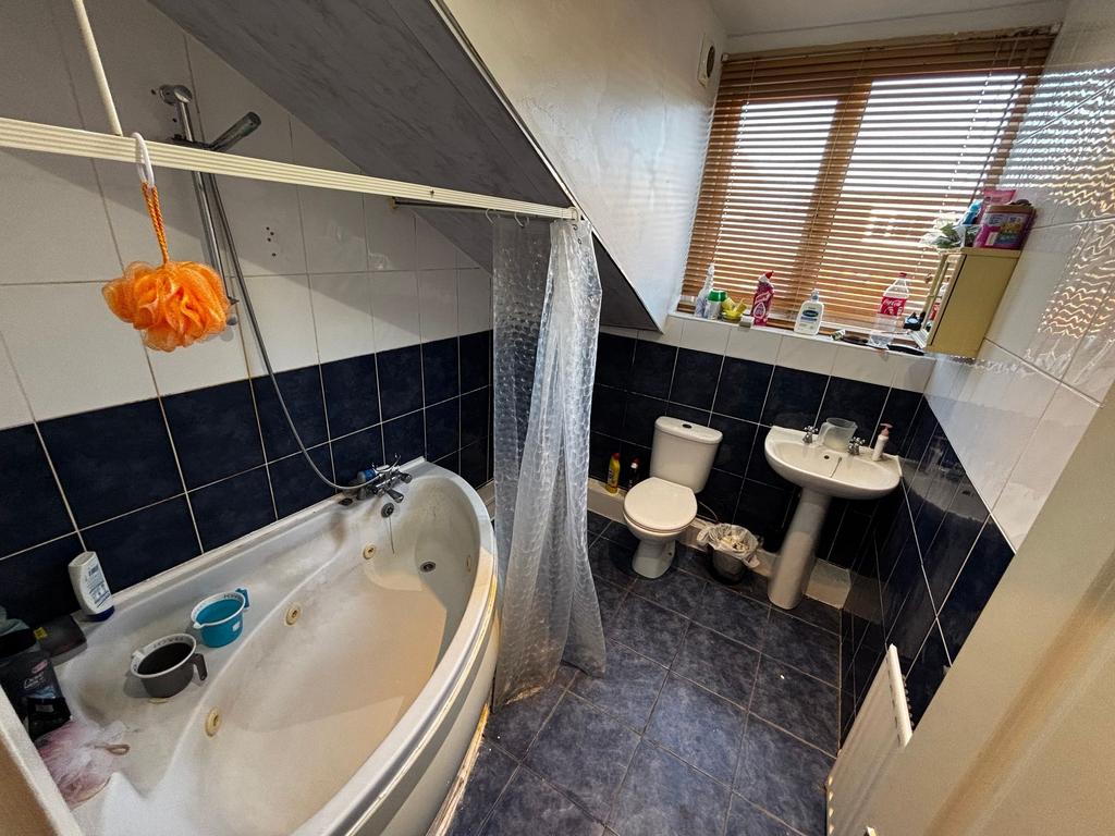 Bright bathroom with a corner jacuzzi-style bat...