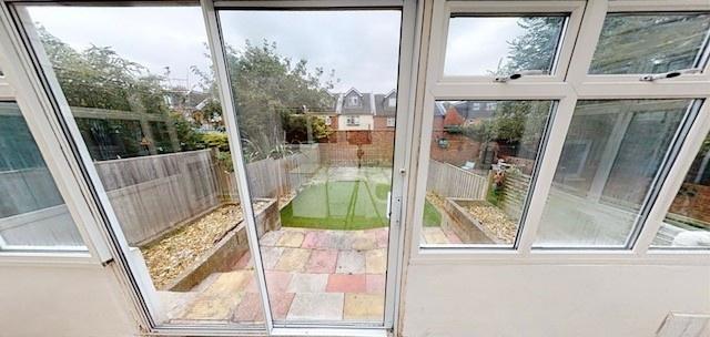 Bright conservatory opening onto a well-kept pr...