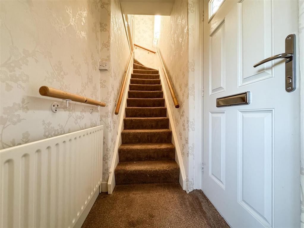 Stairs rising to the first floor