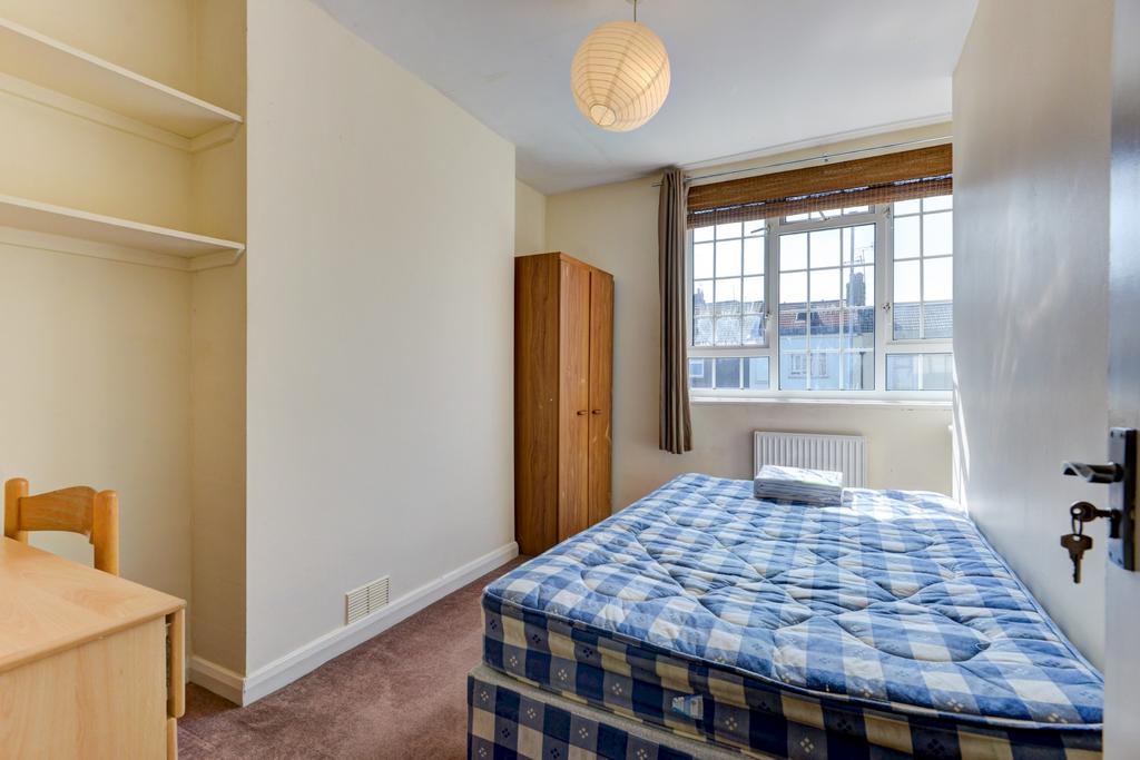 Bright double bedroom with a large sash window ...