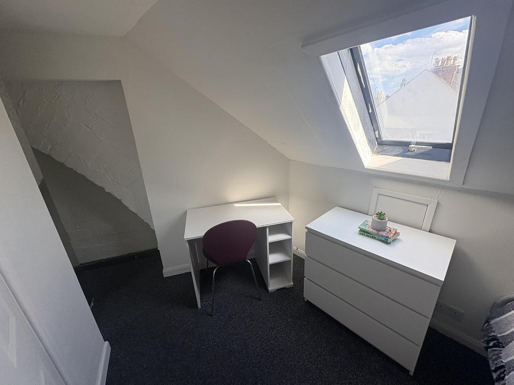 Bright attic single room with desk and storage...