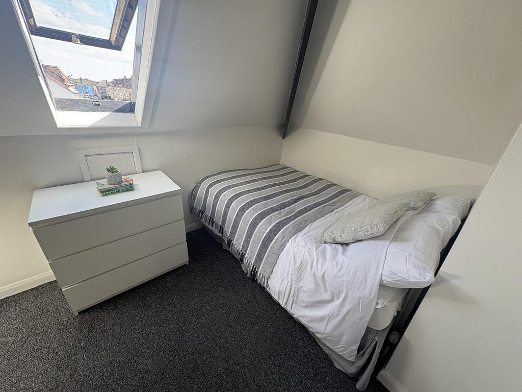 Bright attic single room with dresser and skyli...