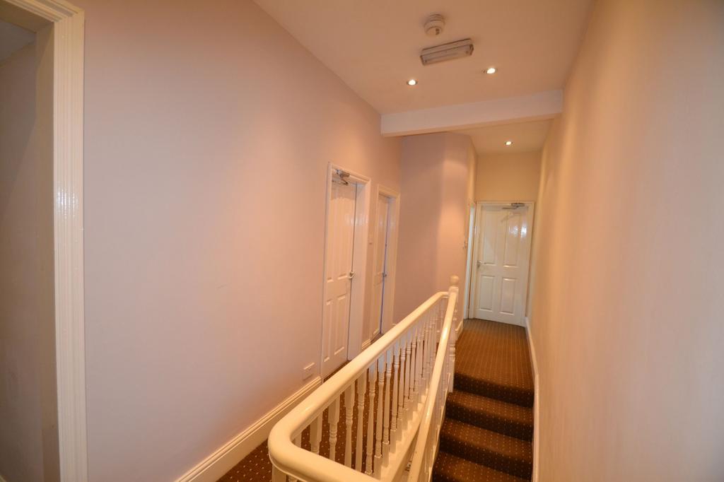 A well-maintained interior hallway with a warm ...