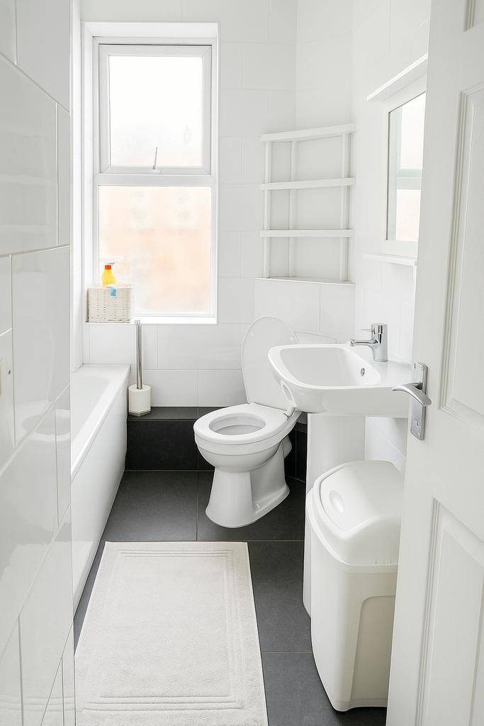 Bright, modern bathroom with clean white tiling...