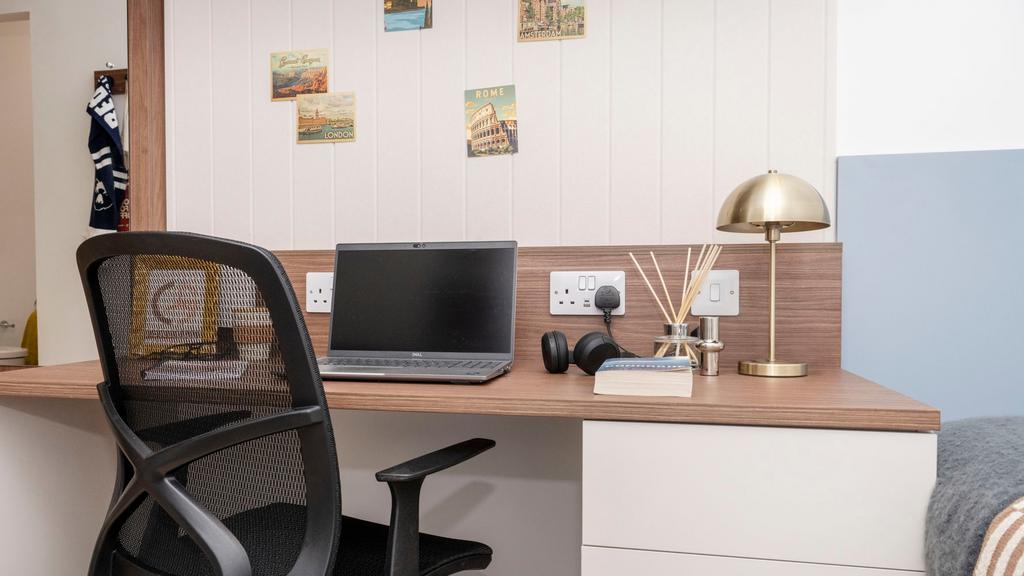 Well-appointed bedroom workspace with a wooden ...