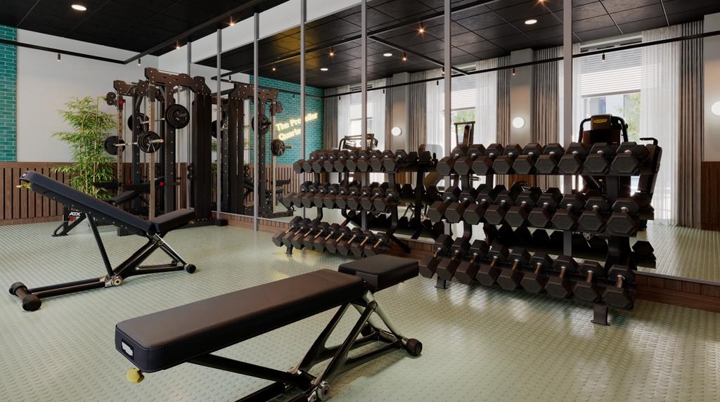 Modern on-site gym with free weights, adjustabl...