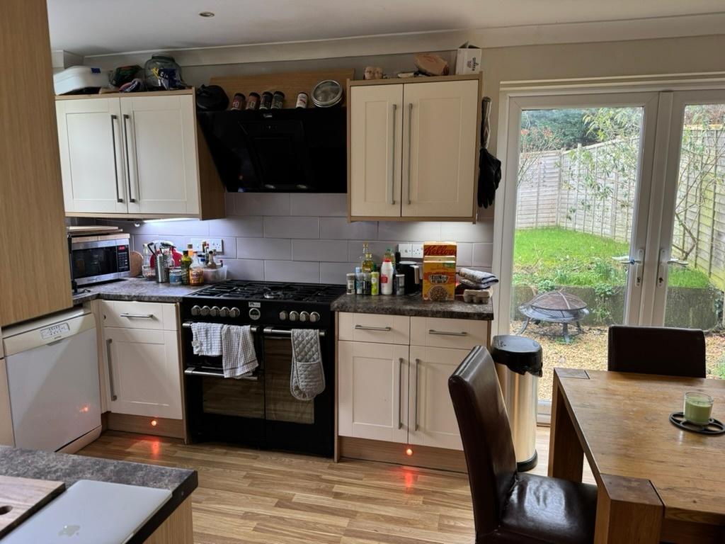 Bright, modern kitchen with a large range cooke...