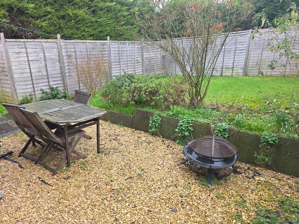 Private rear garden with gravel seating area, w...