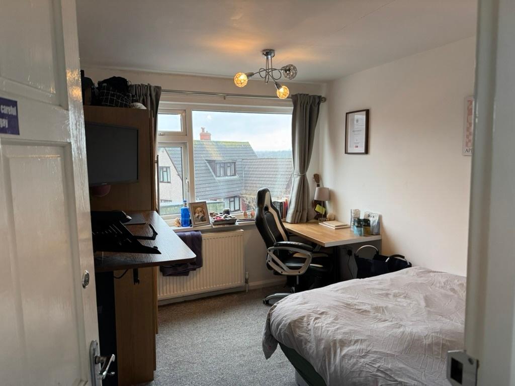 Bright, neatly presented bedroom with a large w...