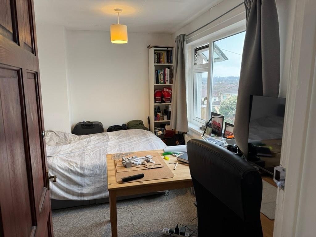 Bright, well-lit bedroom with a comfortable dou...