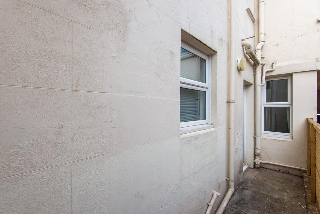 Narrow external side passageway with a window a...