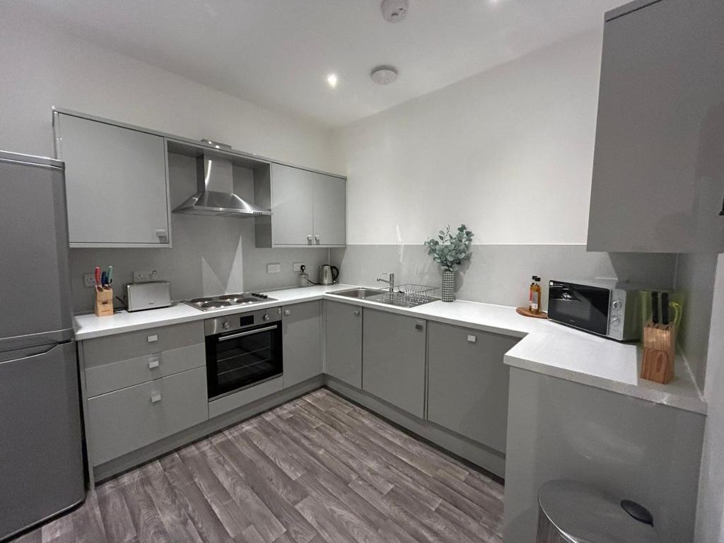 Modern grey kitchen with appliances and worktop...