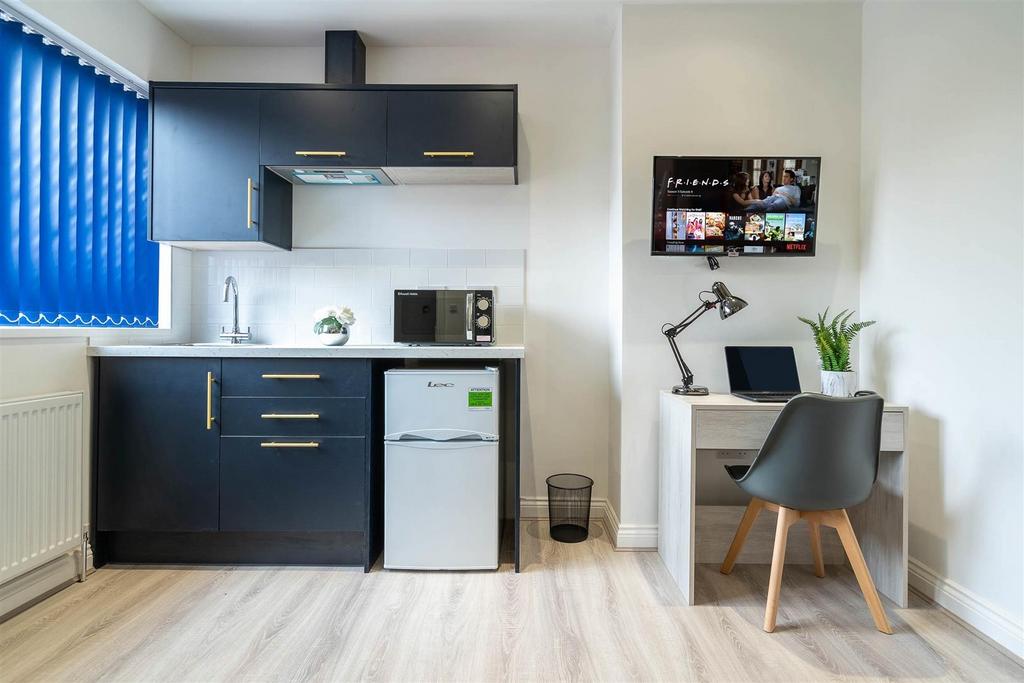 Modern kitchenette with desk and natural light...