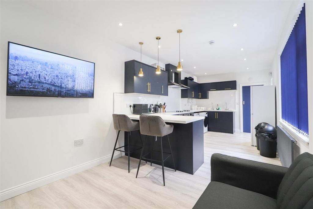 Bright modern open-plan kitchen with island...