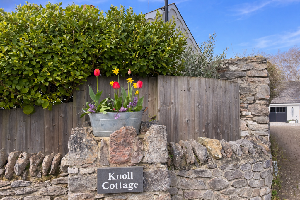 Knoll Cottage entrance with blossoms