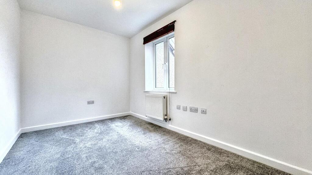 Bright, freshly painted bedroom with carpeted f...
