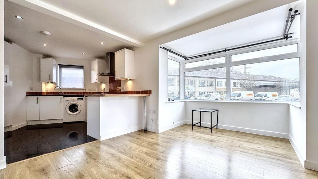 Bright open-plan living area with bay window...