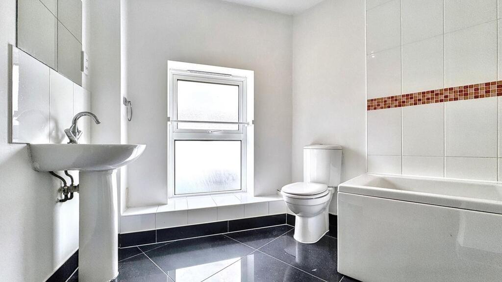 Bright modern bathroom with bathtub and window...