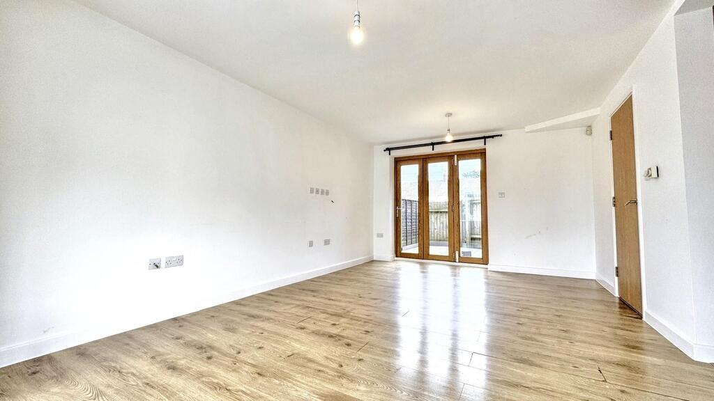 Bright open living room with wooden floors...