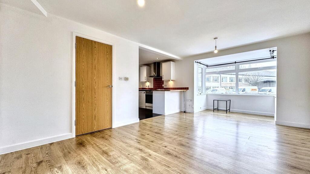Bright open-plan living room with bay window...
