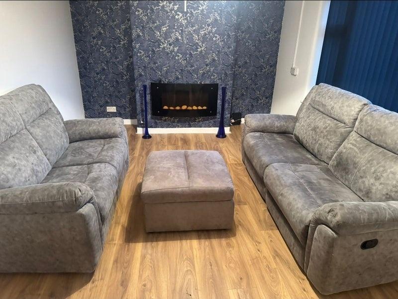 Modern lounge with comfy sofas and electric fir...