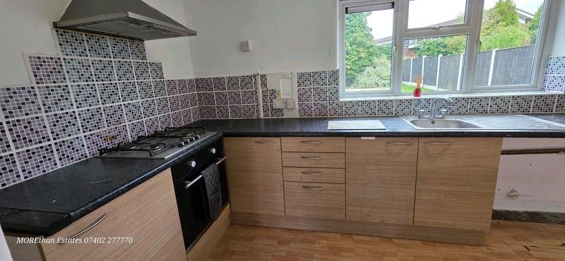 Bright kitchen with built-in hob and sink...