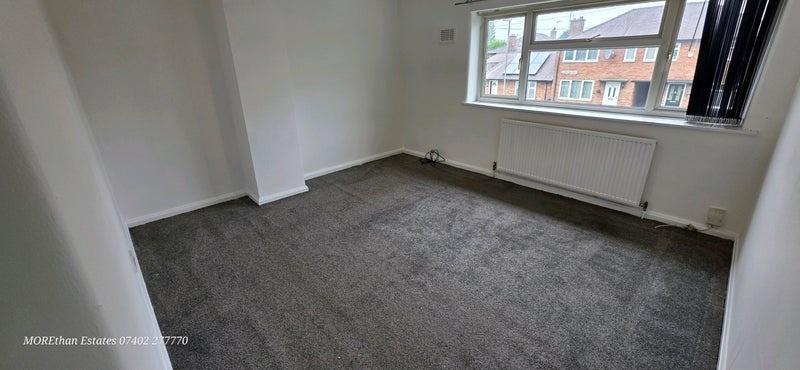Bright unfurnished bedroom with large window...