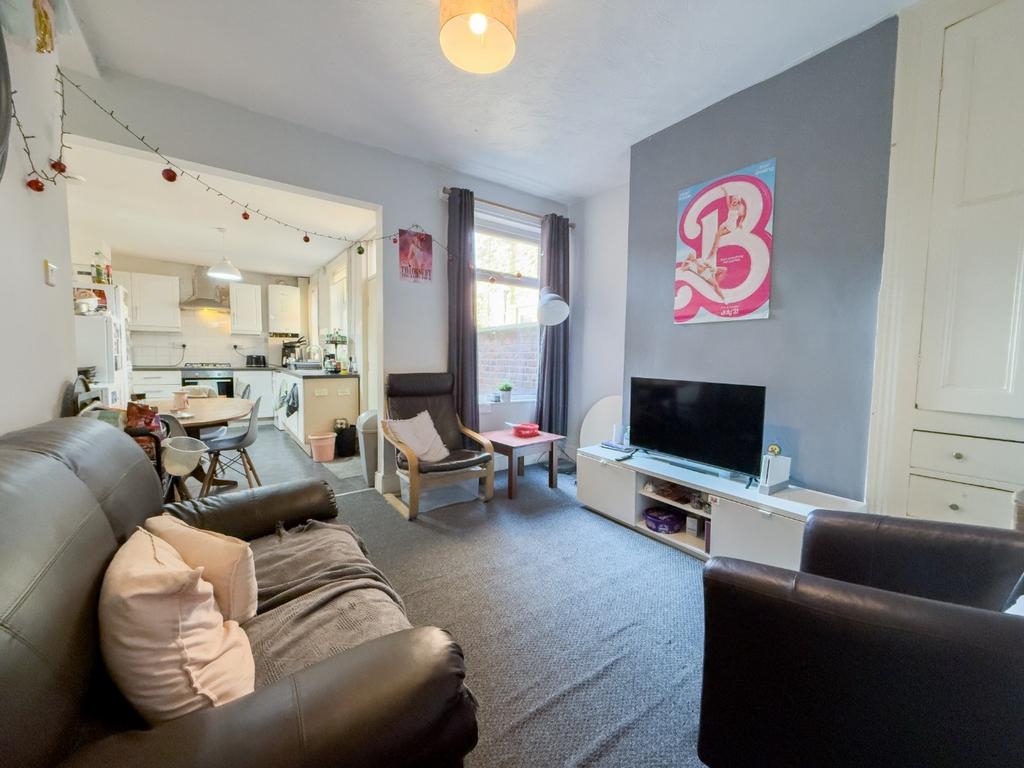 Bright, modern shared lounge with seating and T...