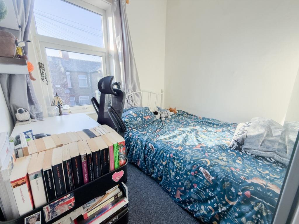 Bright bedroom with desk and shelving...