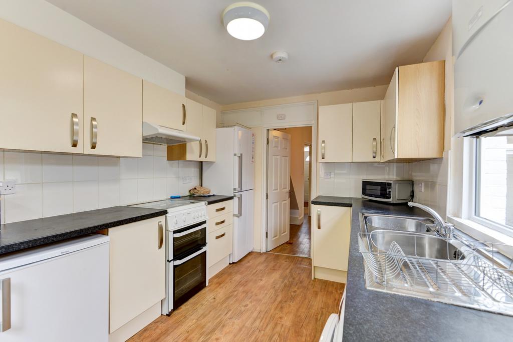 Bright, well-equipped kitchen with plentiful cu...