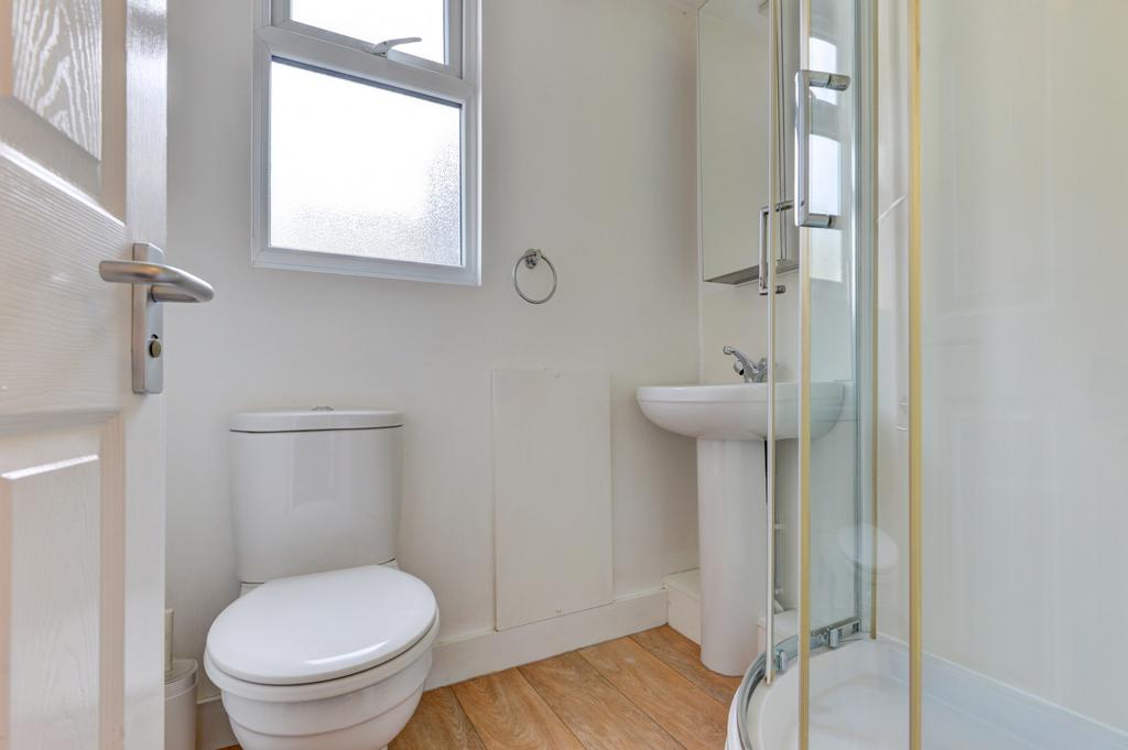 Bright, well-maintained bathroom with a corner ...