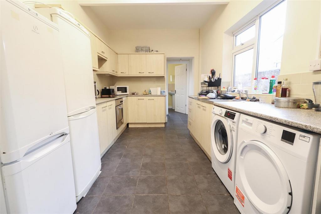 Bright, practical galley kitchen with appliance...