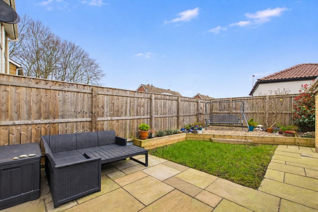 Cozy backyard patio with rattan sofa