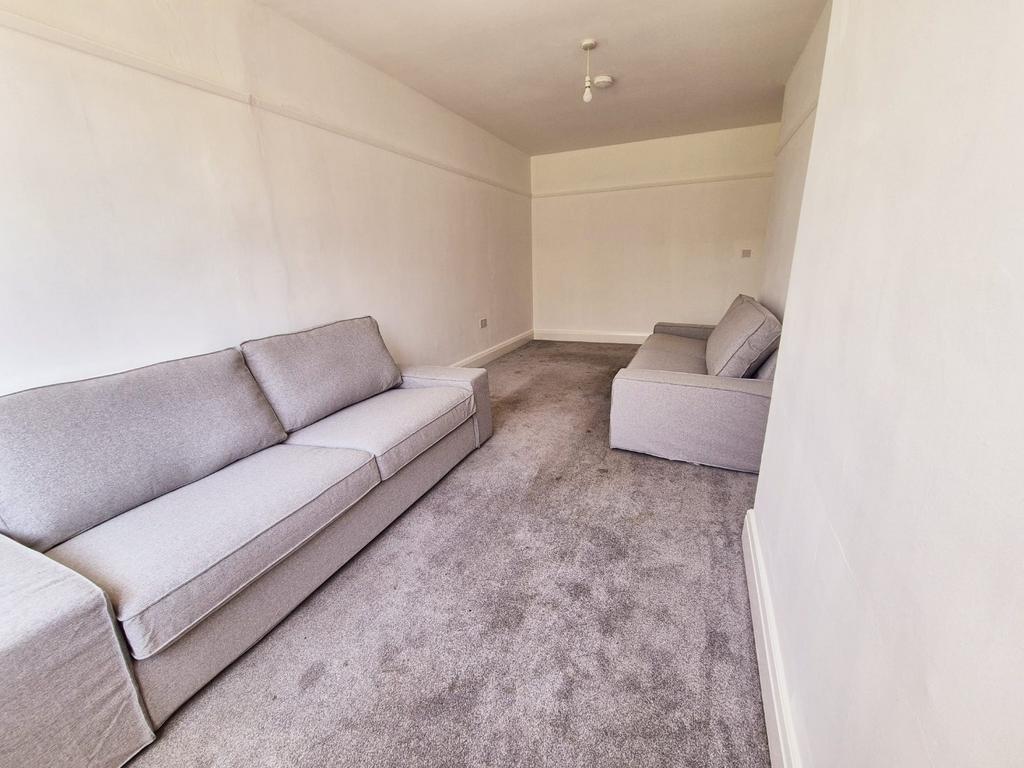 Bright lounge with matching sofas and neutral D...