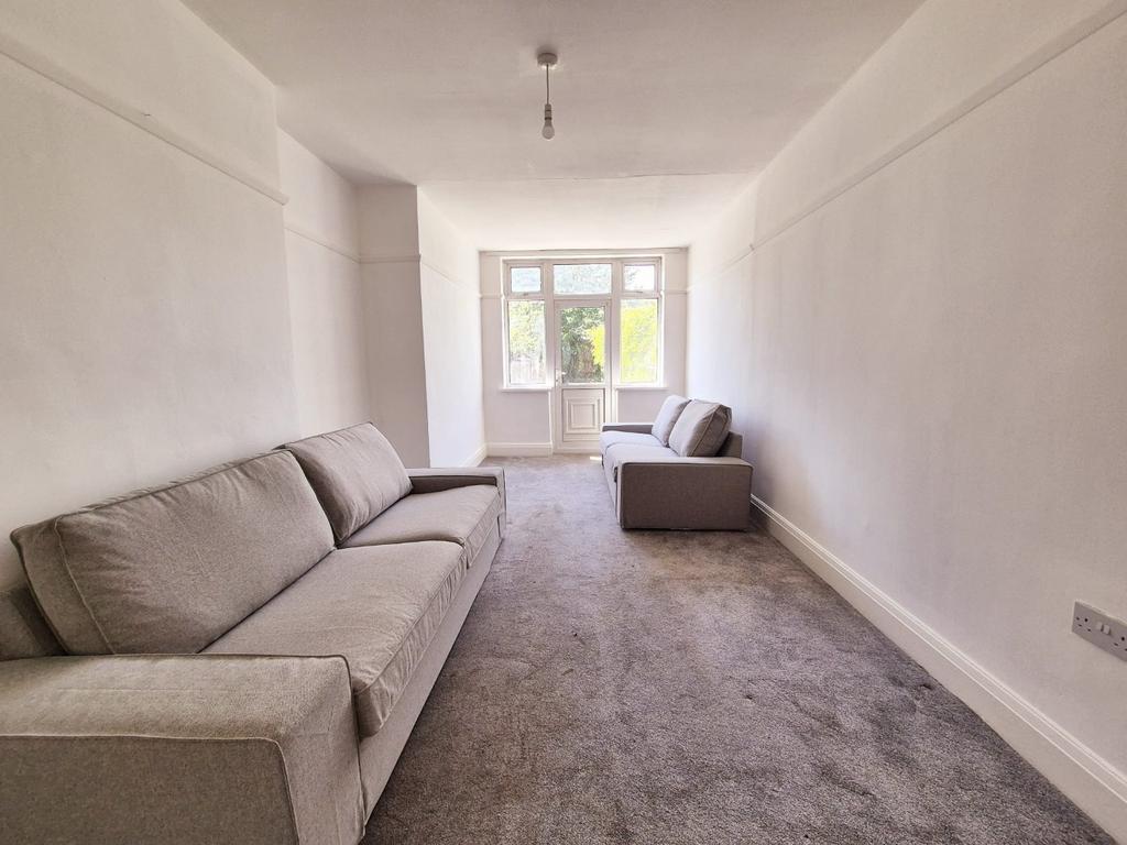 Bright lounge with pale walls and sofas...
