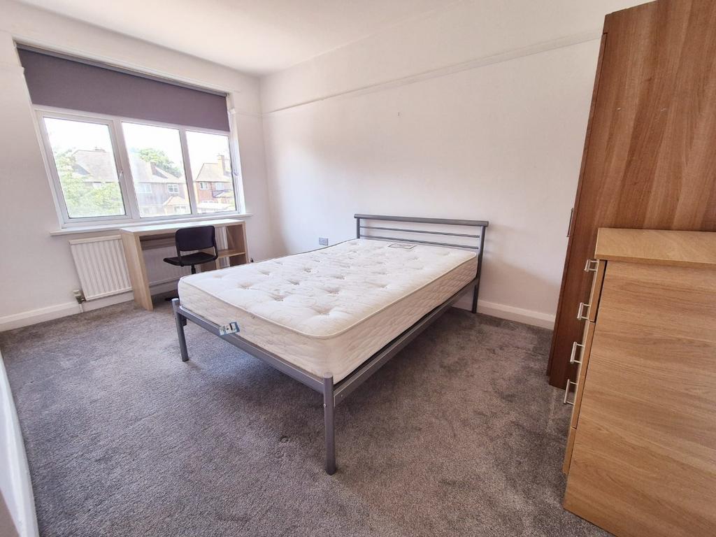Bright bedroom with bed, desk and wardrobe...