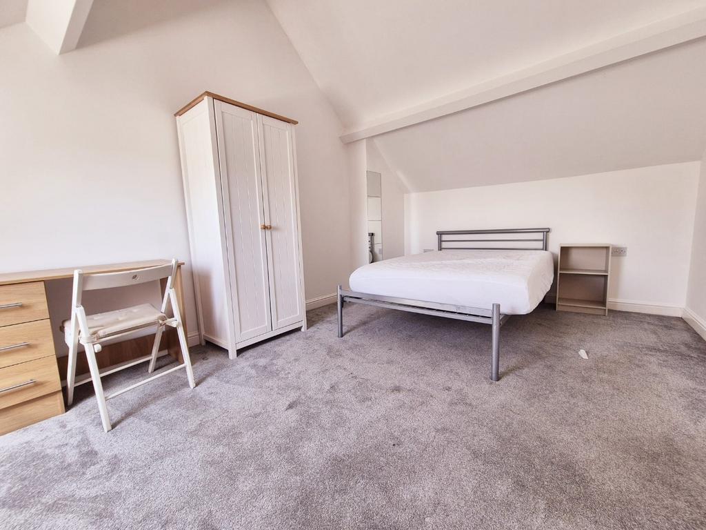 Bright, airy bedroom with storage and desk...