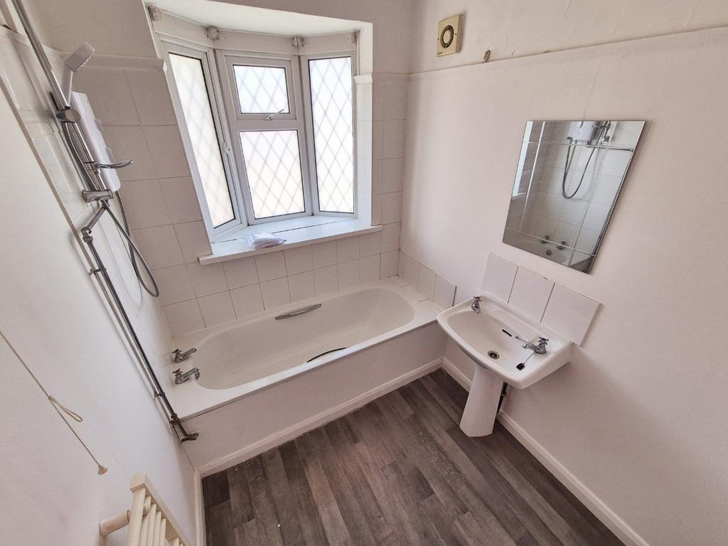 Bright bathroom with bathtub and shower...