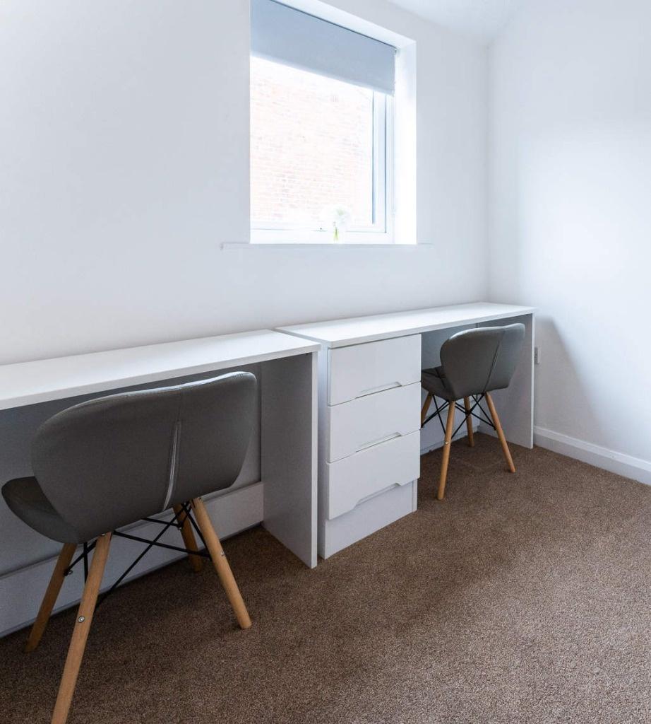 Bright twin study desks under a window...