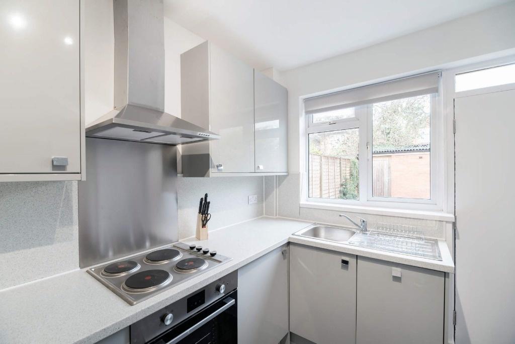 Bright contemporary kitchen with white units...