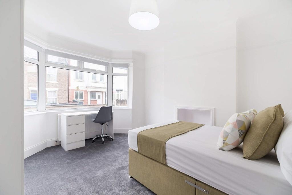Bright bedroom with study nook and bay window...