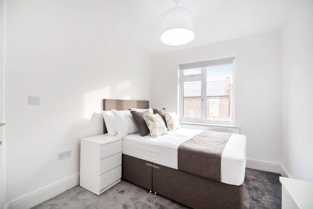Bright, modern bedroom with neutral decor...