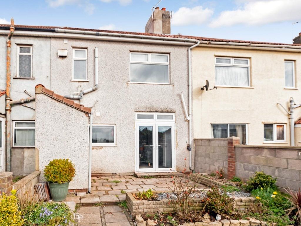 Neat rear exterior with patio and garden plante...