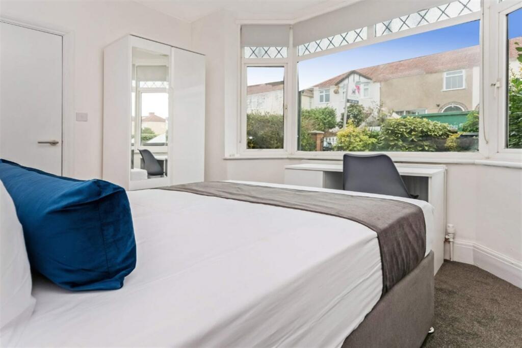 Bright double bedroom with large front window...