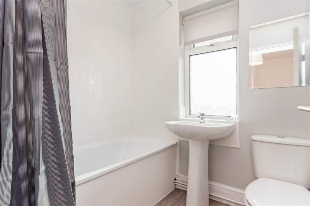 Bright modern bathroom with bath and sink...