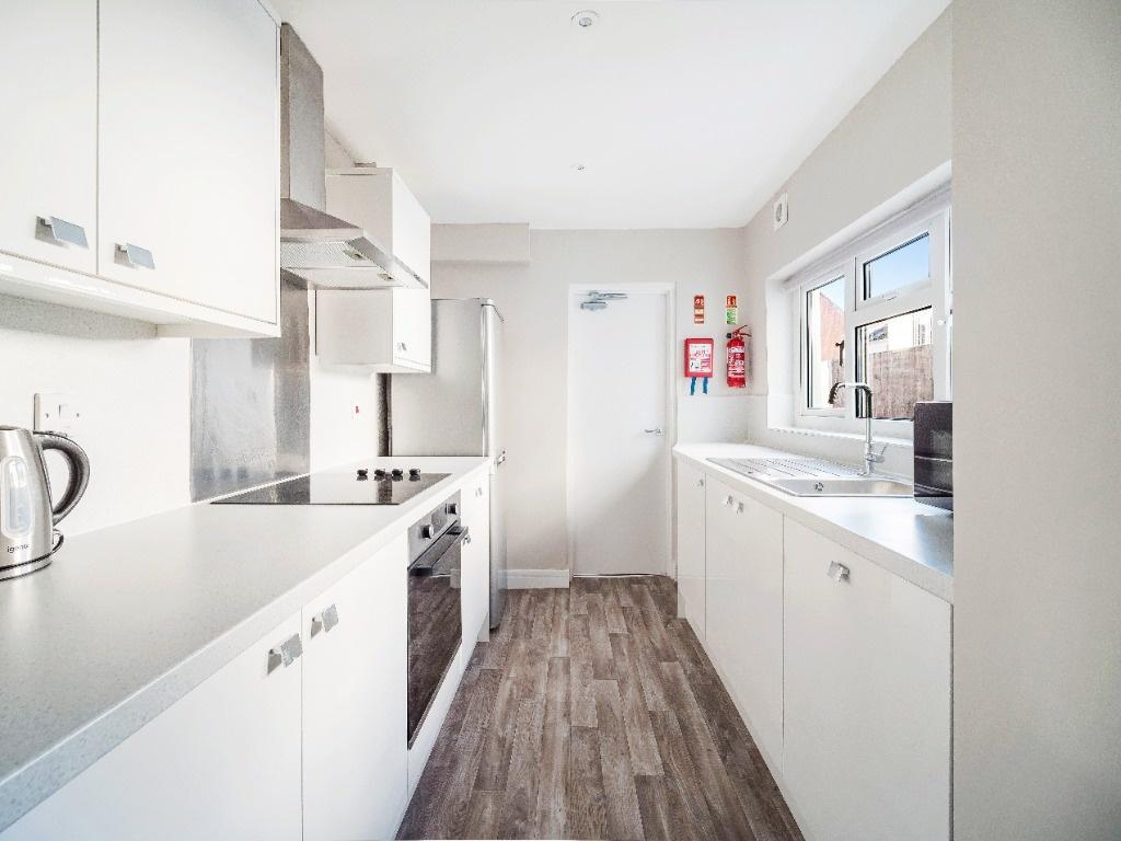 Bright modern galley kitchen with ample storage...