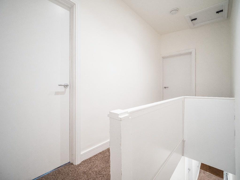 Bright, clean landing with neutral decor...